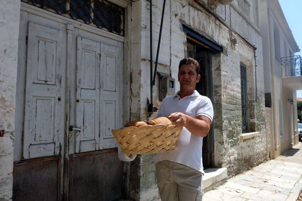 Good boy with bread in Lafkos, one of the most beautiful and authentic mountain villages on the Greek peninsula of Pelion, characterized by an atmospheric square and the absence of cars.