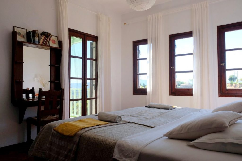 Sleeping room. Modern apartment for rent in Lafkos. Explore the best view just from your bed. Holidays in Greece.