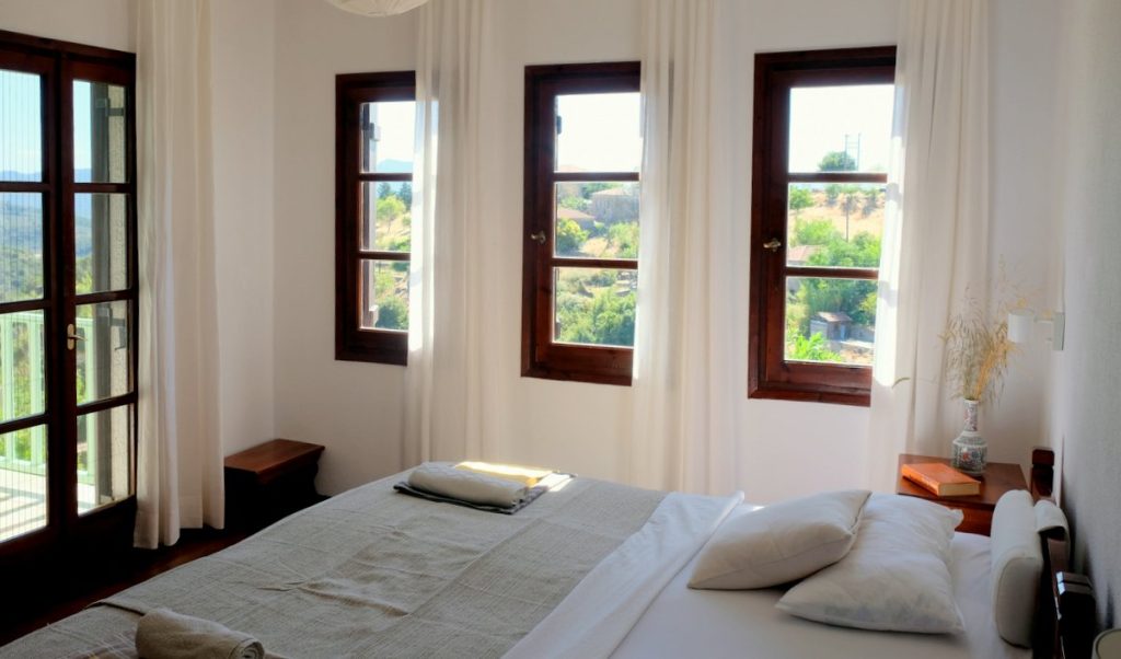 Enjoy the view from the sleeping room. Beautiful apartment near the sea in the charming mountain village of Lafkos.